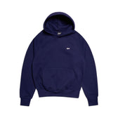 The HOODIE ORBIT BLUE by 6PM is a plain navy blue raglan-sleeved hoodie featuring a kangaroo pocket and a small white chest logo, shown on a white background.