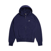 The 6PM ZIP HOODIE ORBIT BLUE is a navy zip-up hoodie with a hood, front pockets, and subtle white logo text on the left chest—ideal for everyday wear and styled here laid flat on a white background.
